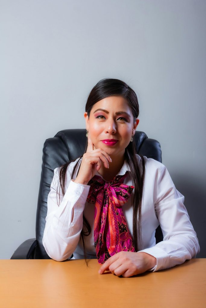 Portrait of a professional woman in an office setting, exuding confidence and poise.